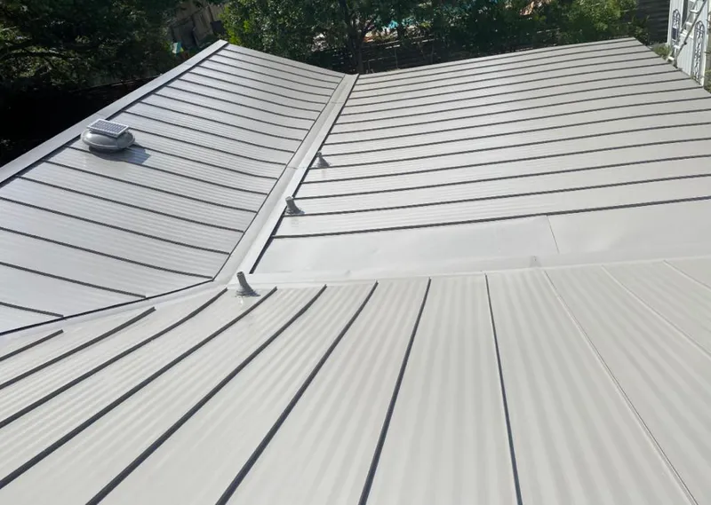 Solar attic fan installed on a metal roof for Roof Ventilation in Louisville